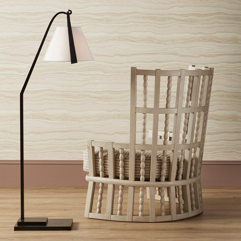 Image of Currey & Company Norene Collection Wing Chair in a room with a black and white floor lamp, hardwood flooring, tan wood grain like wallpaper. The wing chair is in Fog Gray Finish, made of Mindi Wood, Fabric and Foam with Overall Dimensions of 39.6"h x 35.2"w x 28.8"d and weighing 45lbs